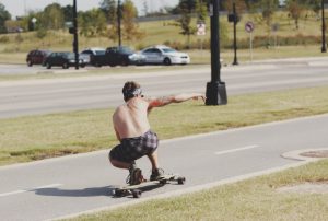 Rider cruising on a longboard on an open road