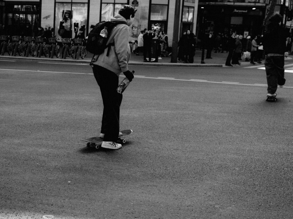 Rider moving across a longboard on a city street