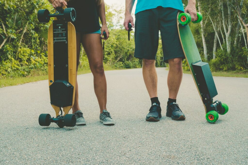 Two riders holding their longboards