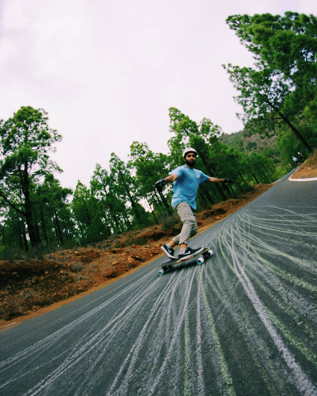 Juan Campuzano doing a backside slide on a mountain road