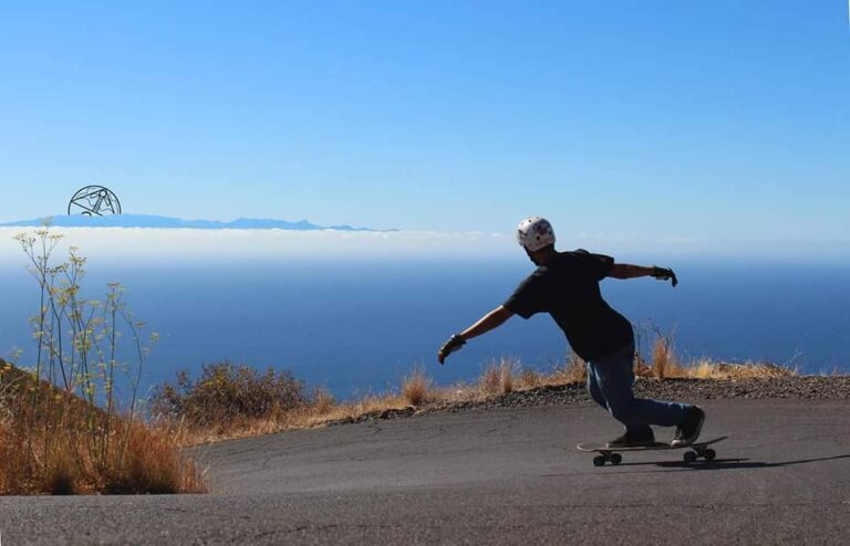Juan Campuzano doing a stand-up slide on a longboard on a coastal road